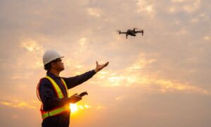 Engineer operating drone for Lidar mapping survey at sunset