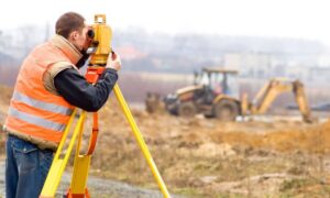 Topographic survey construction site - ALTA SURVEY South Carolina Land surveyor using equipment on a construction site during a topographic survey