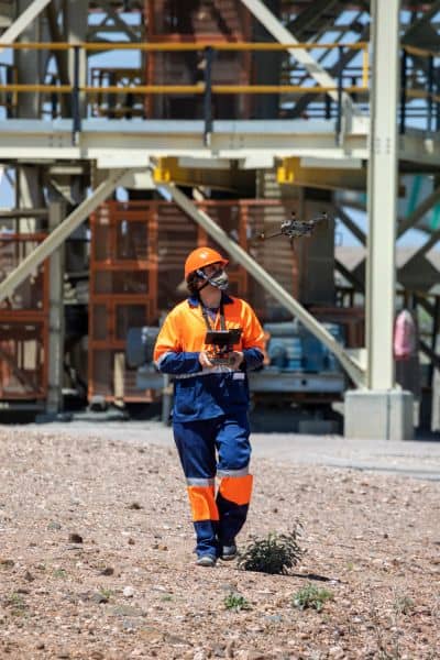 Professional drone surveying operator field - ALTA SURVEY South Carolina Surveyor operating a professional drone at an industrial site for mapping and construction data collection.