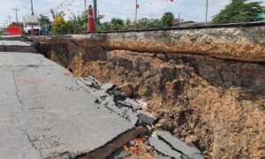 Sinkhole road collapse - ALTA SURVEY South Carolina Large road sinkhole showing collapsed pavement and exposed soil layers, highlighting the need for a construction staking survey