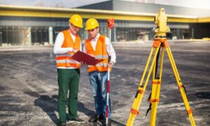 Alta survey commercial property greenville sc - ALTA SURVEY South Carolina Survey crew reviewing plans beside a total station during an ALTA survey for a commercial property in Greenville, SC