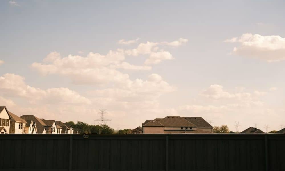 Suburban homes and a fence showing property boundaries on a plat of survey