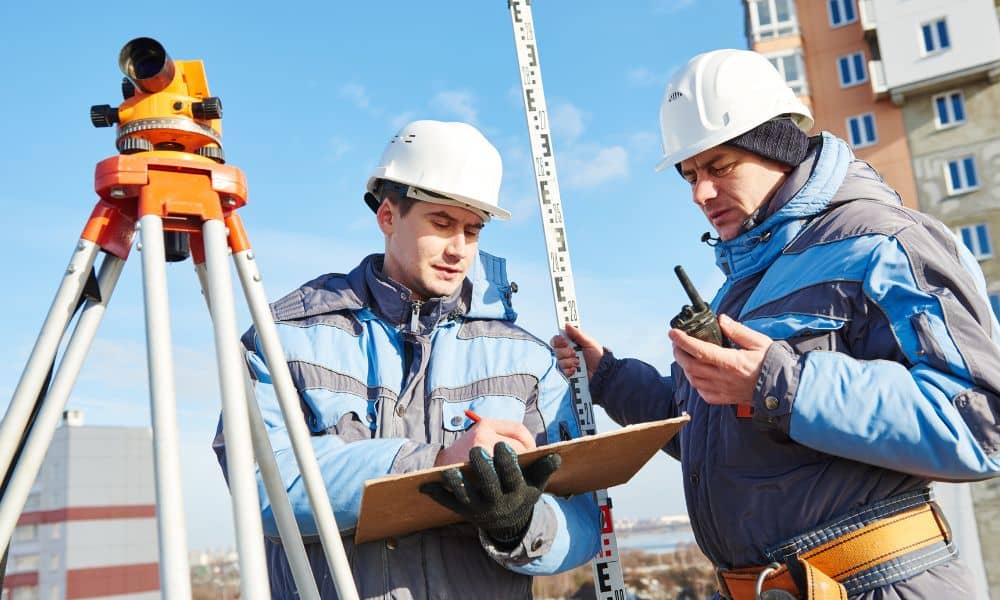 Surveyors measuring property elevation for an elevation certificate
